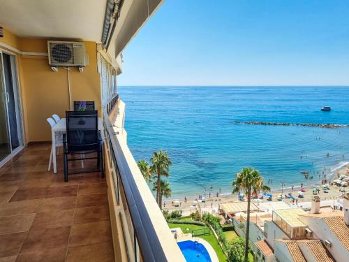 a balcony with a view of the beach and the ocean at Spectacular Sea Views Benalmádena in Benalmádena