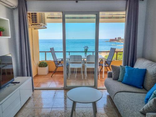 a living room with a view of the ocean at Spectacular Sea Views Benalmádena in Benalmádena