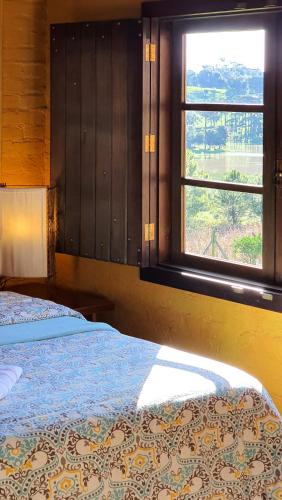 Una cama o camas en una habitación de Loft no campo próximo ao Vale dos Vinhedos