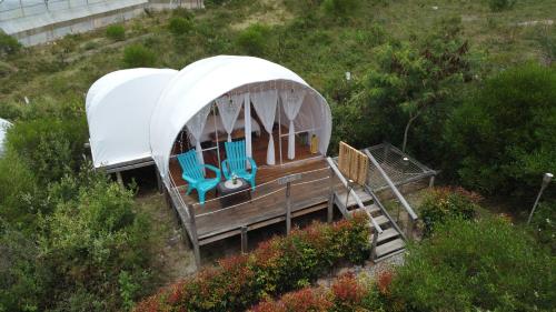 a small house on a hill with a slide at Origen Glamping en Villa de Leyva in Villa de Leyva