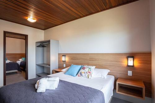 a hotel room with a large bed with towels on it at Parador Casa da Praia in Torres