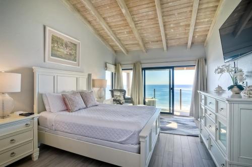 a bedroom with a bed and a view of the ocean at Oceanfront Views, Heated Pool, Hot Tubs, Parking in Solana Beach