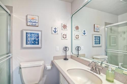 a bathroom with a toilet and a sink and a mirror at Oceanfront Views, Heated Pool, Hot Tubs, Parking in Solana Beach