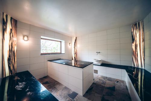 a bathroom with a sink and a bath tub at Aktivhotel Wildschütz in Altmünster