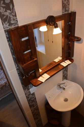 a bathroom with a sink and a mirror at Fachwerk in Yaremche