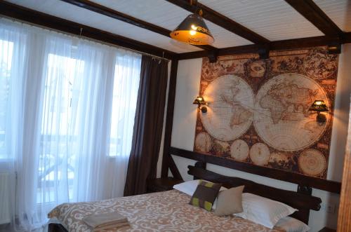 a bedroom with a bed with a map on the wall at Fachwerk in Yaremche