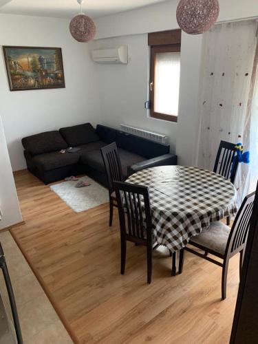 a living room with a table and chairs and a couch at Lilo in Dobra Voda