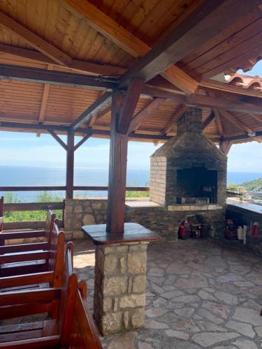 an outdoor altar with a stone fireplace and benches at Lilo in Dobra Voda