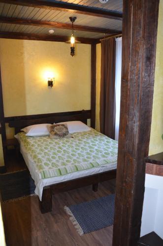 a bedroom with a wooden bed in a room at Fachwerk in Yaremche
