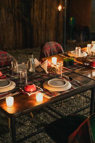 a wooden table with plates and dishes on it at Everest Base Camp, Near George Everest House, 5kms from Library chowk in Mussoorie