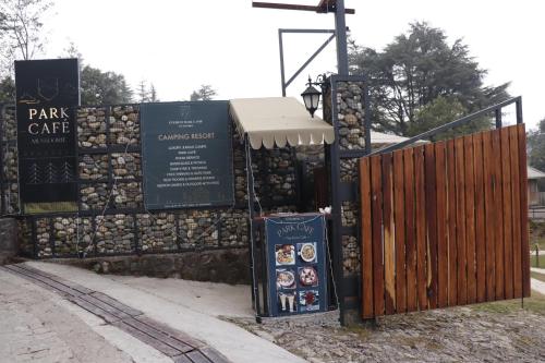 a park gate with a sign next to a fence at Everest Base Camp, Near George Everest House, 5kms from Library chowk in Mussoorie