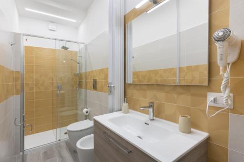 a bathroom with a sink and a shower and a toilet at DELEDDA HOME in Cagliari