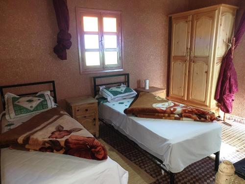 A bed or beds in a room at Camping Hôtel la Vallée d'Ammelne
