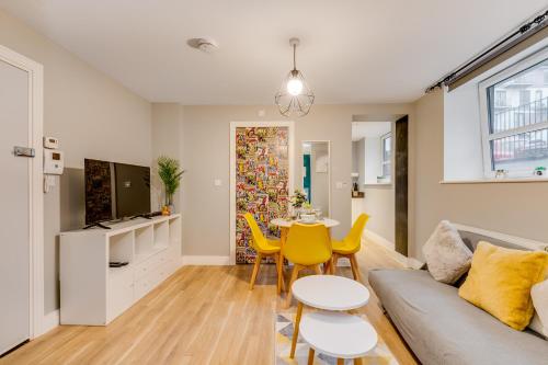 a living room with a couch and a table at Modern Living Stevenage 1 bed apartment Town Centre Tesco at Doorstep up to 4 people in Stevenage