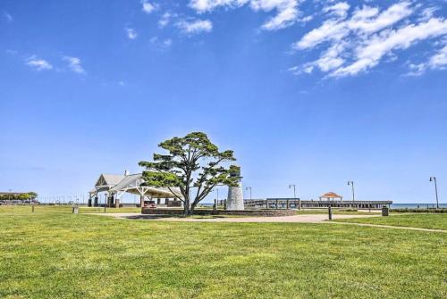 a tree in a field in front of a building at Minutes to the beach! 4-bedroom home, free parking in Hampton