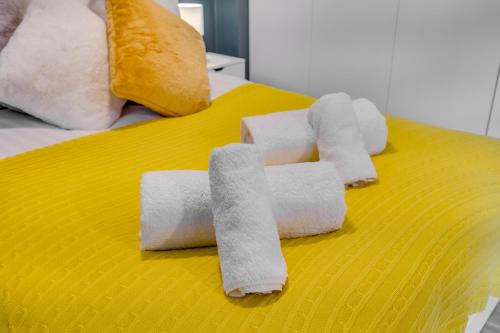 a pile of rolled up towels on a bed at Modern Living Stevenage 1 bed apartment Town Centre Tesco at Doorstep up to 4 people in Stevenage