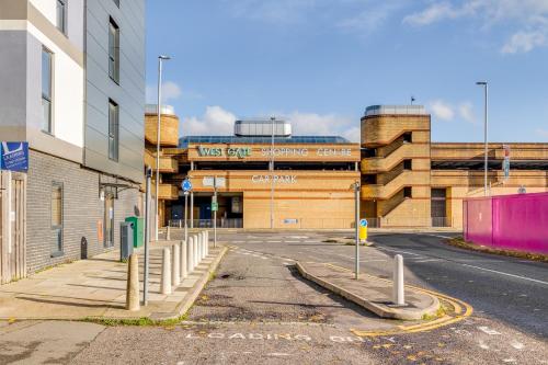 an empty street in front of a building at Modern Living Stevenage 1 bed apartment Town Centre Tesco at Doorstep up to 4 people in Stevenage