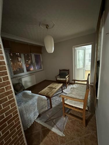 a room with a bed and a table and a chair at lovely 2 bedrooms apartment with full furniture in Beylikduzu