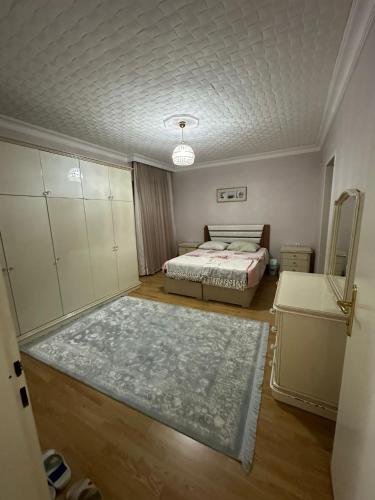 a bedroom with a bed and a room with a bed sqor at lovely 2 bedrooms apartment with full furniture in Beylikduzu