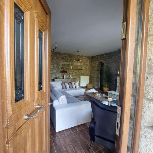 a living room with a couch and a table at PS House Polydrosos - PS Rental in Polydrossos