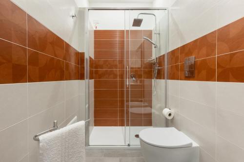 a bathroom with a toilet and a shower at DELEDDA HOME in Cagliari