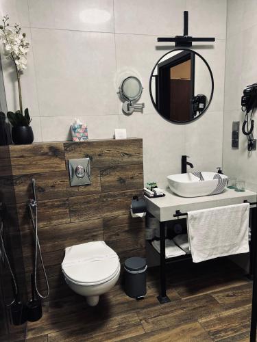 a bathroom with a toilet and a sink and a mirror at Global Home - Aparthotel - No Contact Check In in Mielec
