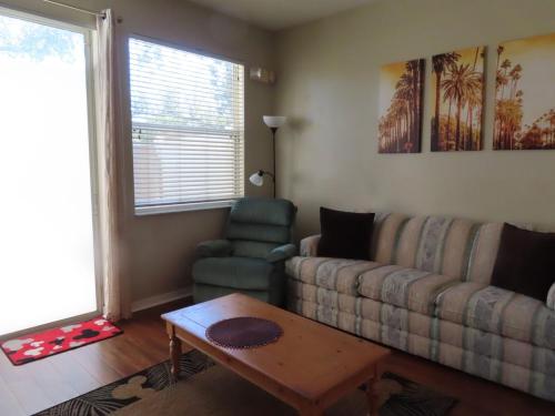 a living room with a couch and a coffee table at Kissimmee townhome 3 miles to Disney! in Orlando