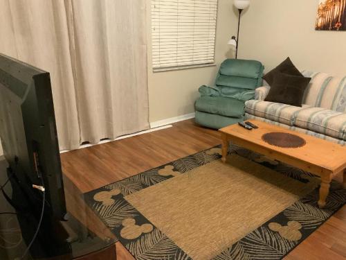 a living room with a couch and a table at Kissimmee townhome 3 miles to Disney! in Orlando