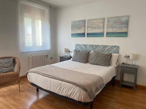 ein Schlafzimmer mit einem Bett mit zwei Tischen und zwei Fenstern in der Unterkunft SUITE VINTAGE LEON in León