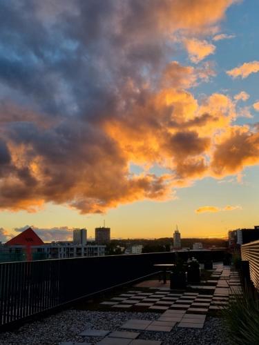 a view of the sunset from the roof of a building at RentPlanet - Apartamenty Chlebova II in Gdańsk