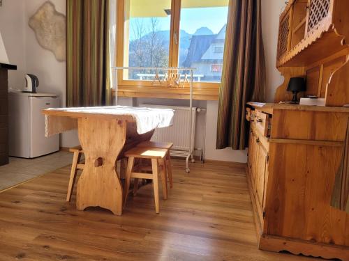 a table and chairs in a room with a window at Willa Strumyk in Zakopane