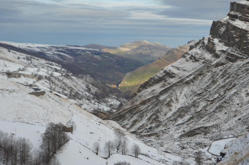 a snow covered mountain with trees and a valley at Posada La Vieja Escuela in San Roque de Ríomiera