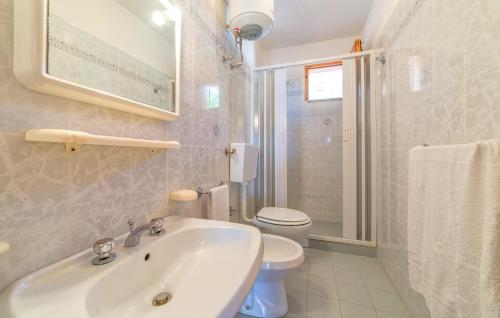 a white bathroom with a sink and a toilet at Fronte Mare Capo San Marco in Sciacca