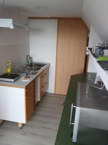 a kitchen with a sink and a counter top at Áfonyácska Vendégház in Mátraszentimre
