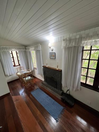 a living room with a fireplace in a house at Chalés da montanha in Itaipava