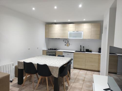 a kitchen with a table and chairs in a room at Costa House in Nazaré