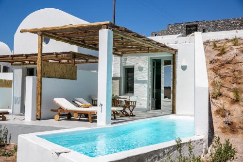 a villa with a swimming pool next to a house at Thimari Lodge in Fira