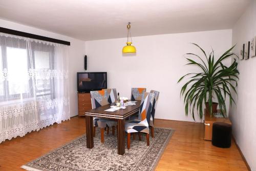 a dining room with a table and chairs at Ubytovanie Viktória in Dunajská Streda