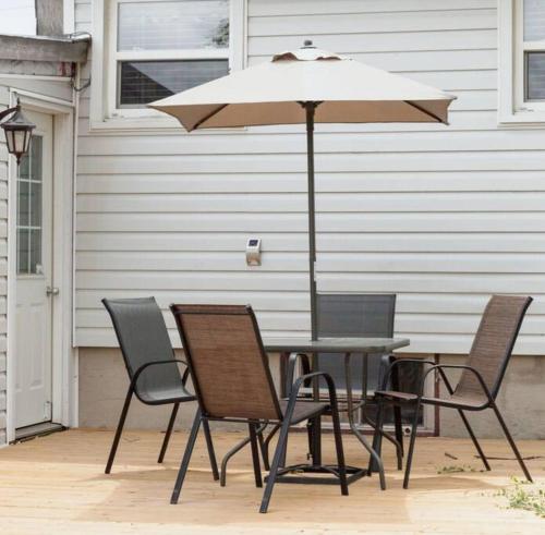 a table and chairs with an umbrella on a patio at Steps to Lake on the Mountain - License ST-2020-0324 R1 in Picton