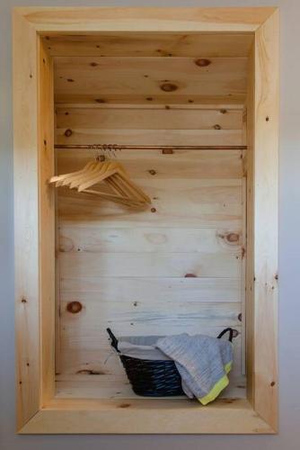 a wooden shelf with a basket in a wooden wall at Steps to Lake on the Mountain - License ST-2020-0324 R1 in Picton