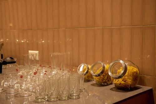 a table with clear glasses on top of it at HILUX COURTYARD in Palakkad