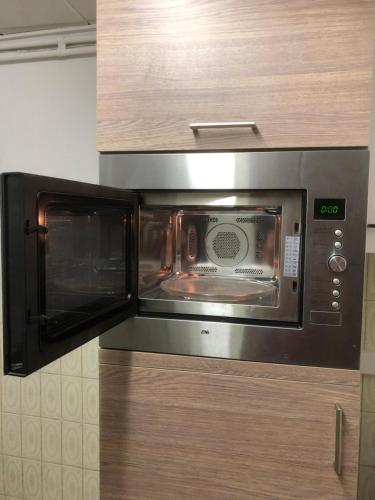 a microwave oven sitting on top of a cabinet at Appartement centre ville in Tournai
