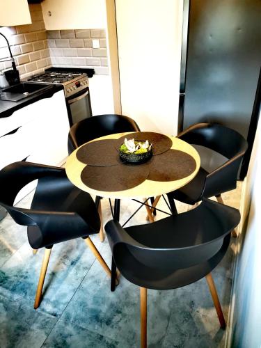 a table with chairs and a bowl of food on it at Chillout-aparts in Świeradów-Zdrój