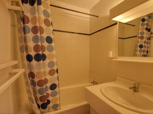 a bathroom with a sink and a shower curtain at Appartement Morillon 1100, 3 pièces, 6 personnes - FR-1-642-37 in Morillon