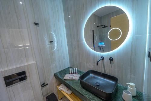 a bathroom with a black sink and a mirror at ELA apartments in Volos