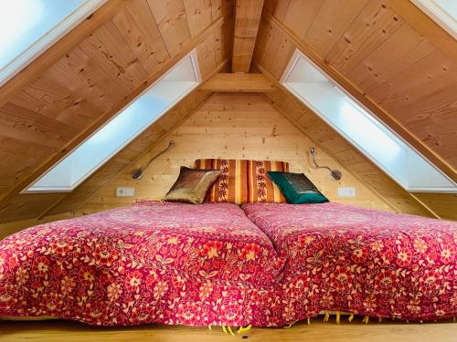 a bedroom with a large bed in a attic at Tiny House/Waldhaus - Westerwald 