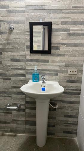 a white sink in a bathroom with a mirror at Finca el Paraíso in San Gil