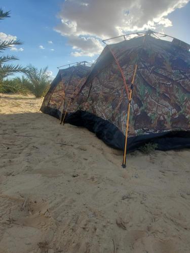 a tent sitting on the sand on a beach at 2 pers tent in Siwa