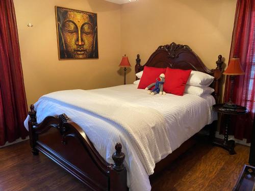 a teddy bear sitting on top of a bed at Inn136 Guest House in Kingsville