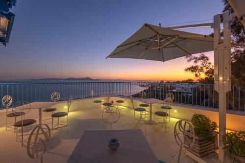 a patio with tables and chairs and an umbrella at La Demeure in Sidi Bou Saïd